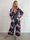 Pams Raise Jumpsuit - Elastisk buksedragt med blomsterr og guldsommerfugle