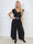 Nicole - Jumpsuit med vida ben, glittrande trådar, fina strass och söta volangärmar