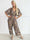 Pams Tribal Jumpsuit - Elastisk mønstret buksedragt med små guld blomster