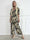 Pams Gold Leaf Jumpsuit - Elastisk buksedragt med blad mønster og guld dutter