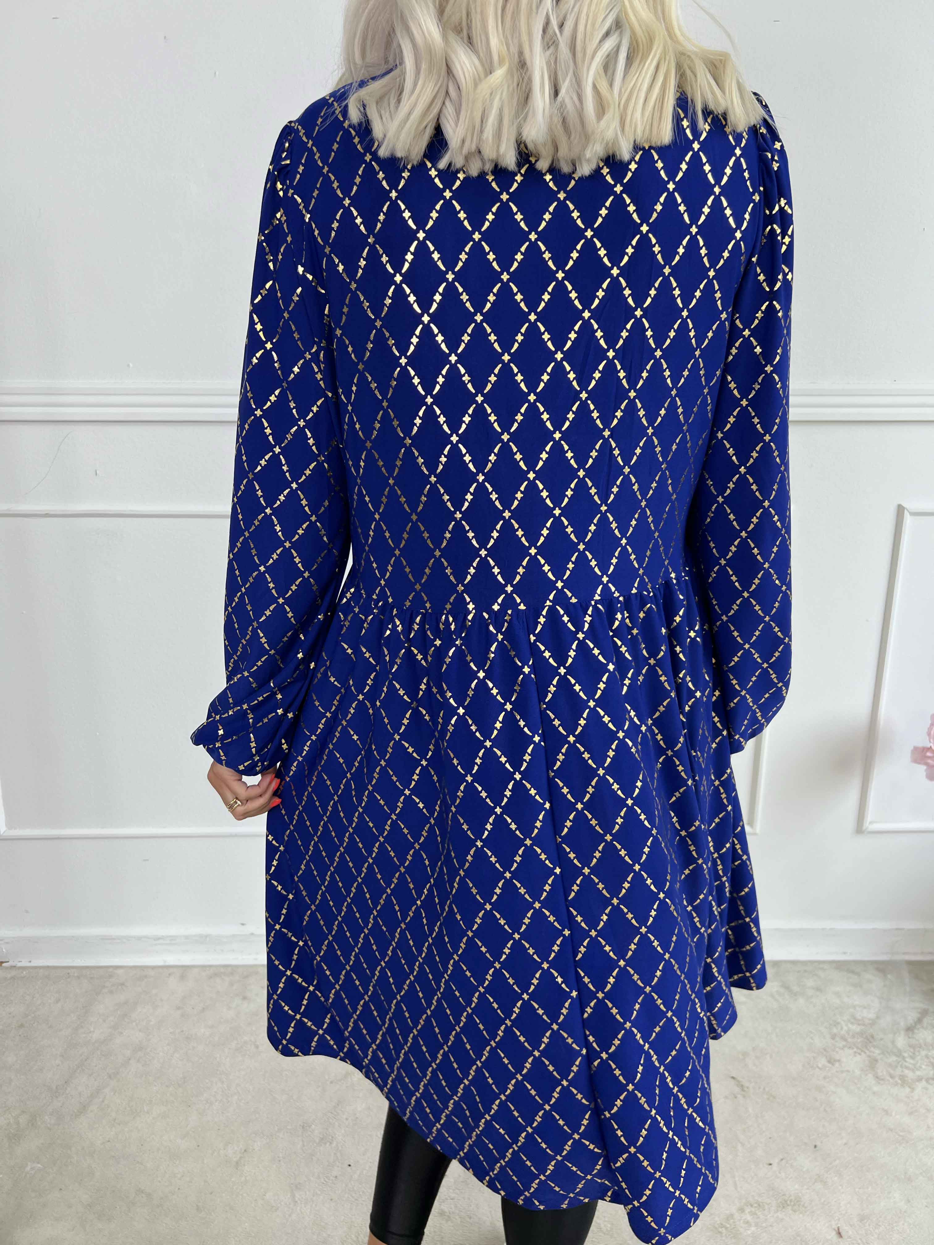 Cersei Gold Check - Babydoll klänning med guldfärgat mönster och rosetter