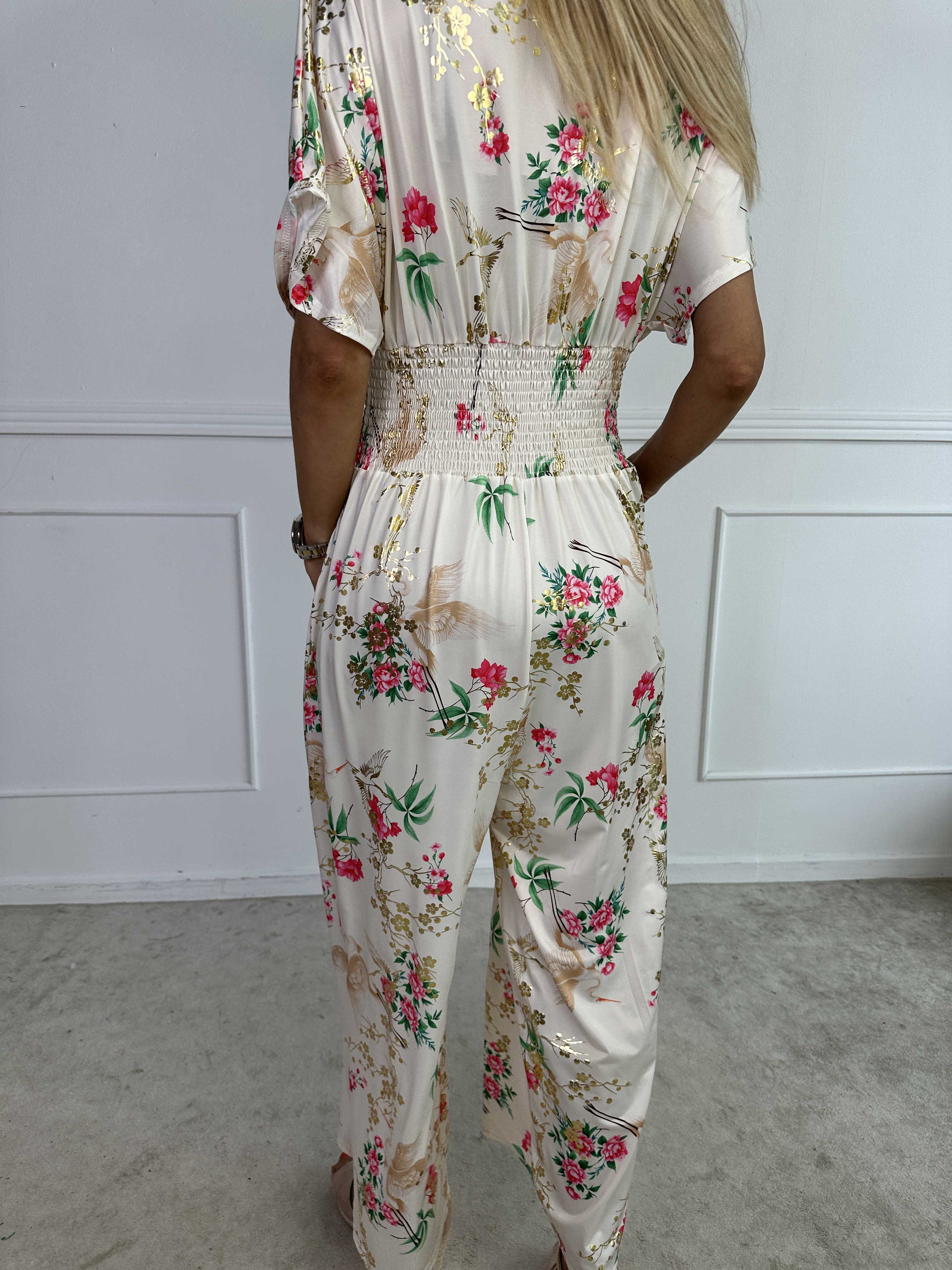 Pams Fly Jumpsuit - Elastisk byxdress med blommor- och fågelmönster
