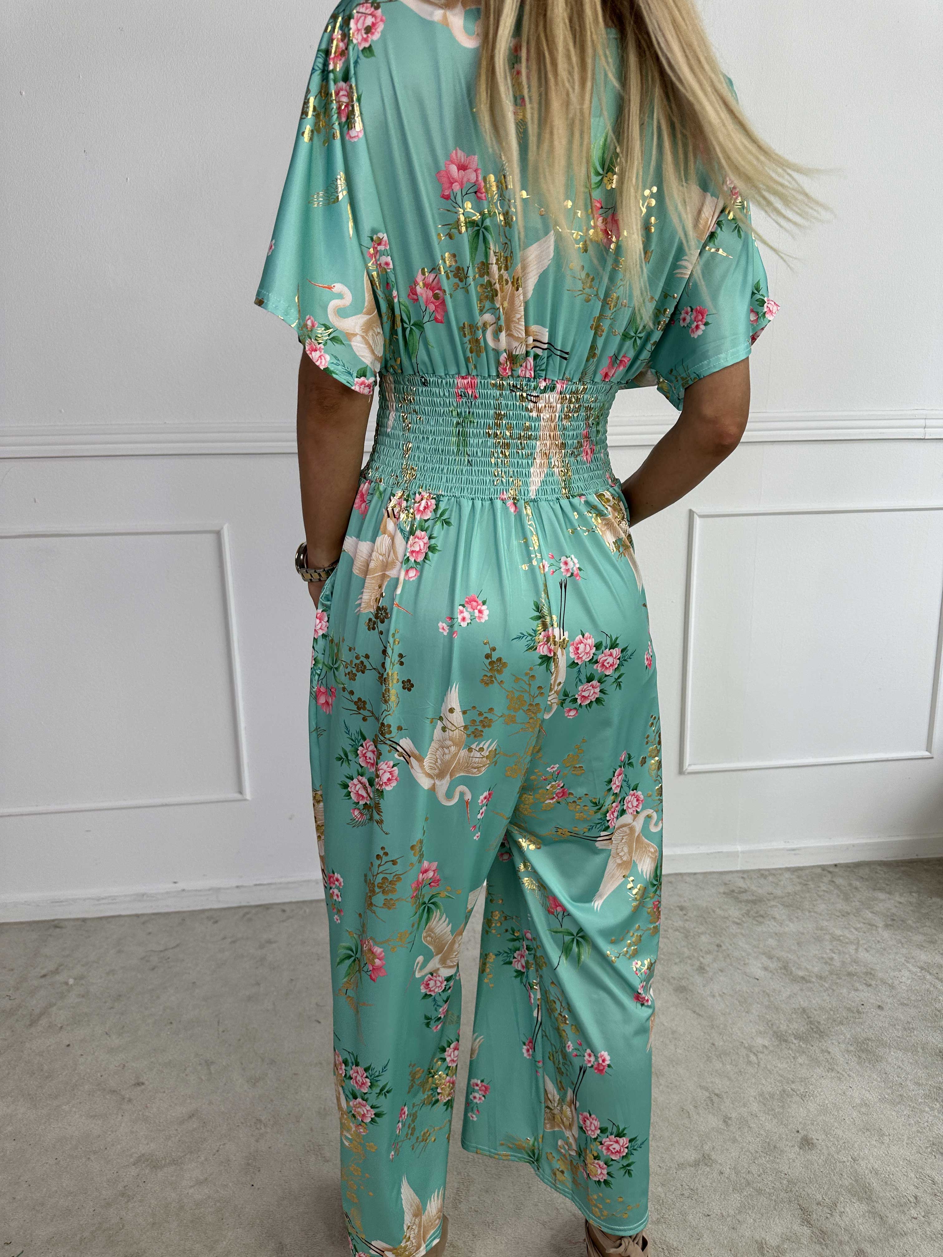 Pams Fly Jumpsuit - Elastisk byxdress med blommor- och fågelmönster