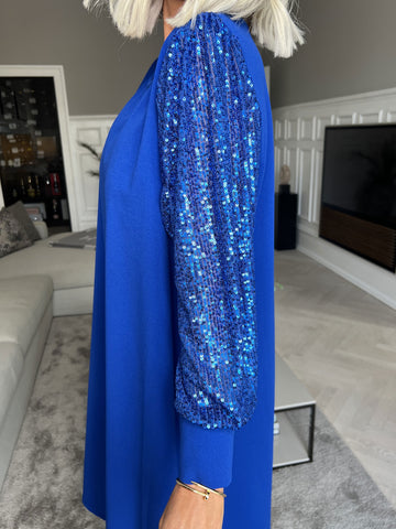 Djamila - Fin klänning med paljettärmar
